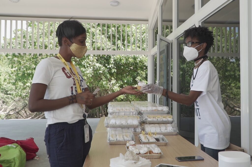itel staff being handed branded cupcakes at itel's brand reveal grab n' go onsite celebration