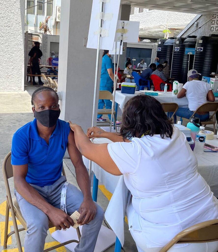 Image of an itel employee receiving his voluntary COVID-19 vaccination during the company's vaccine blitz in Kingston, Jamaica