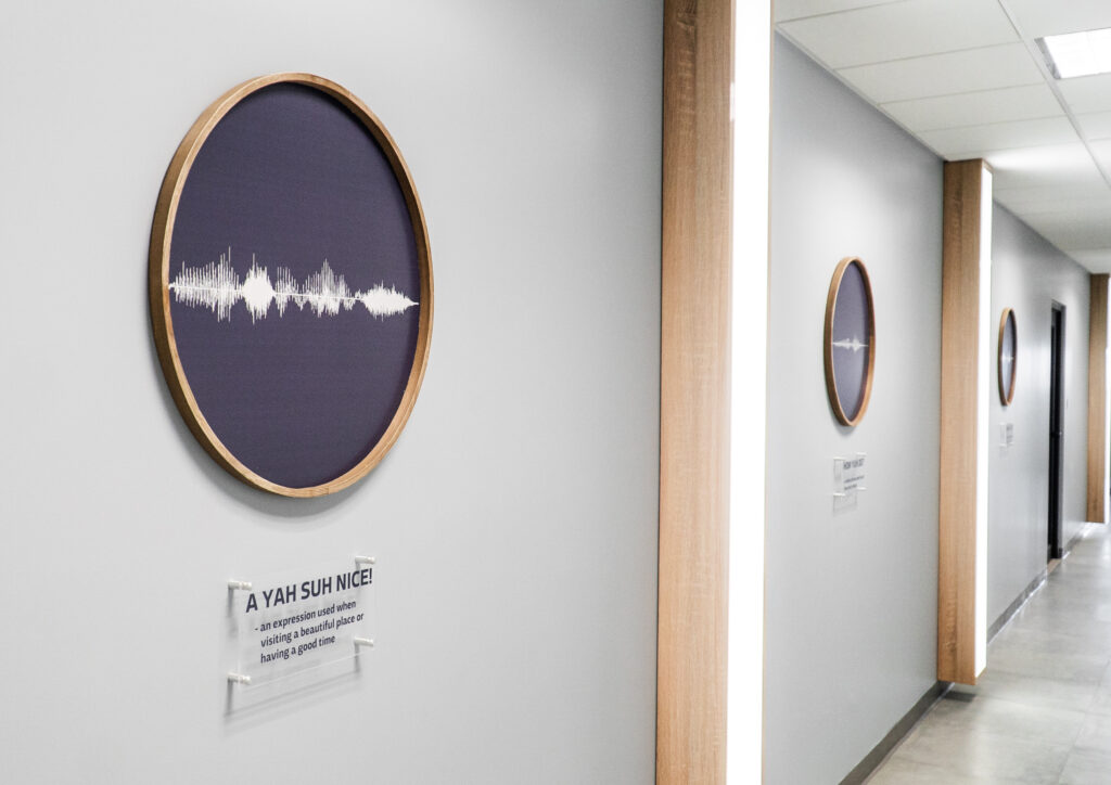 Image of the inside of itel's Chalmers building in Kingston, Jamaica. One of the buildings unique design features, artwork showing visual depictions of sound waves of common Jamaican sayings.